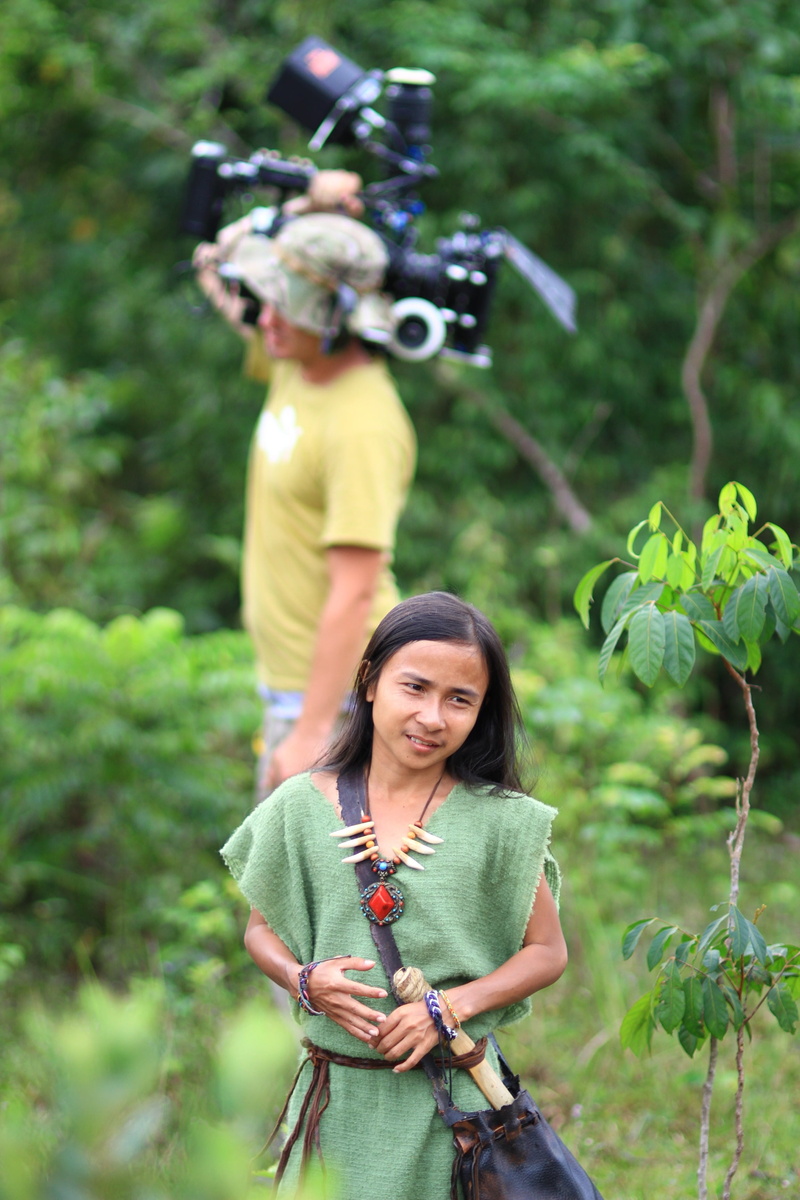 tree, plant, holding, casual clothing, green color, performance, gadget, standing, hairstyle, women, cinema, 2K, real people, video, costume, females