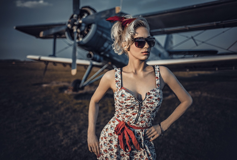 Antonov An-2, women with glasses, transportation, outdoors, women, focus on foreground, beauty, day, hairstyle, standing, waist up, beautiful woman, lifestyles