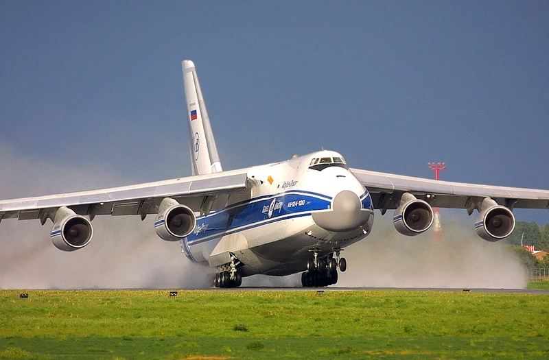 military, no people, clear sky, airplane, land, outdoors, stationary, plant, white, nature, airport runway, day, airport, Antonov, cargo, grass, Ruslan