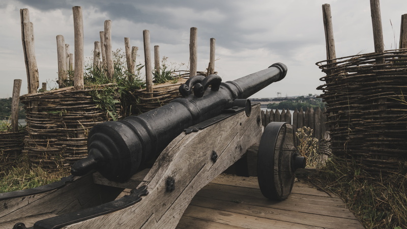 history, plant, nature, day, tool, sky, cloud - sky, war, weapon, outdoors, cannon, construction, metal, wood - material, artillery, architecture, conflict