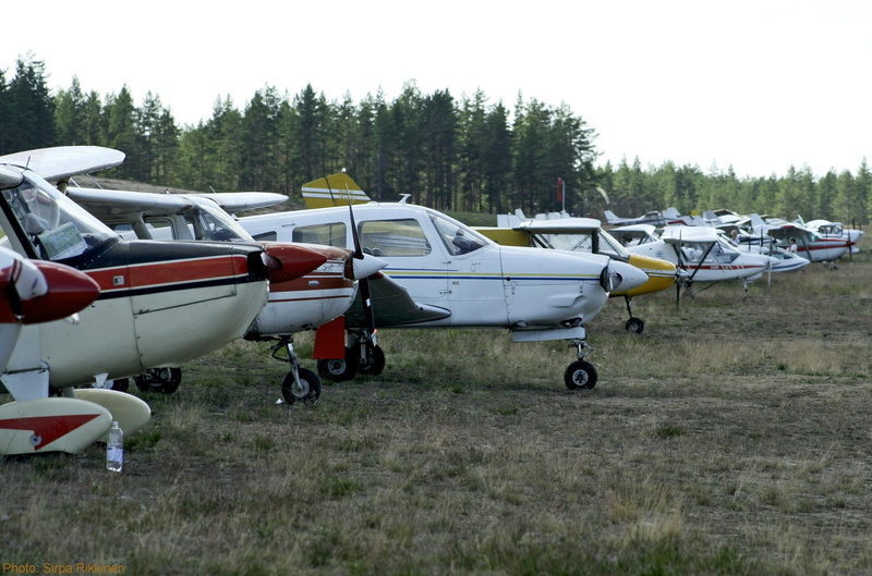 flight, fuselage, mode of transportation, airport, day, pilot, side view, nature, aircraft, travel, environment, aviation, no people, tree, wing, grass
