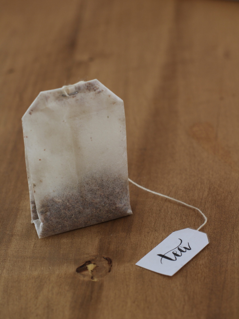 4K, paper, focus on foreground, still life, indoors, no people, table, high angle view, text, wood - material, teabag, selective focus, day, herbal tea
