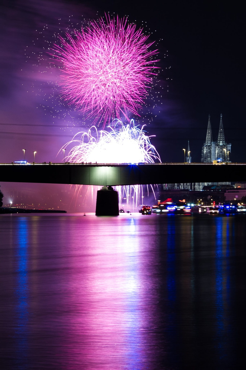 purple, celebrate, shower of sparks, celebration, display, building exterior, show, waterfront, city, nighttime, firework - man made object, water, motion