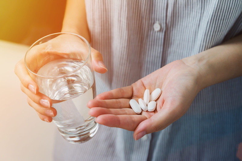 human hand, one person, taking, drink, round, medication, holding, pill container, small, taking medicine, water, hand, indoors, close-up, drinking glass