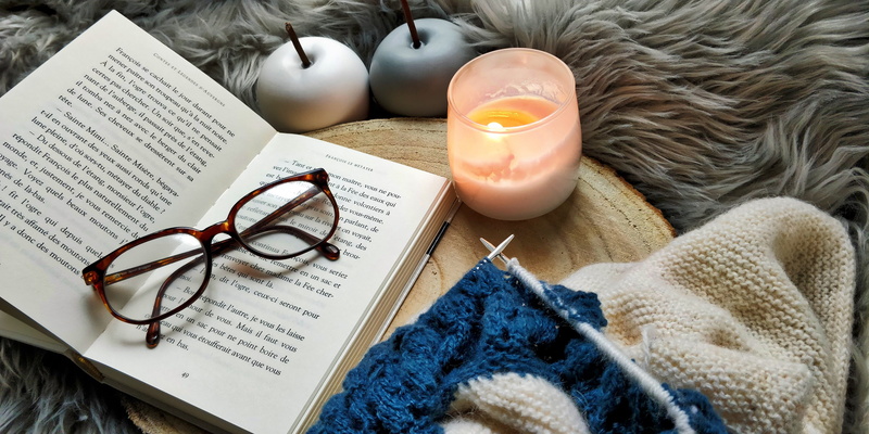 candle, flame, graphics, drink, floral design, page, table, lifestyles, indoors, novel, france, paper, home decor, book, warm clothing, eyeglasses, accessories