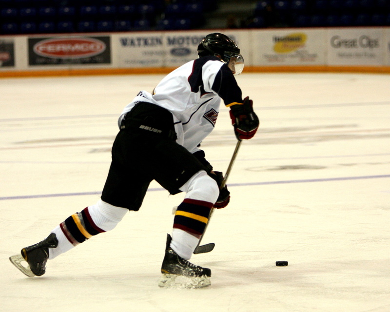 taking a shot - sport, helmet, stadium, winter, winter sport, shooting at goal, sport, competition, ice rink, game, motion, real people, cold temperature