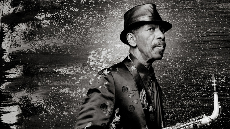 photography, mouth open, water, waist up, adult, portrait, hat, young men, leisure activity, day, grayscale, one person, saxophone, looking, holding, mid adult