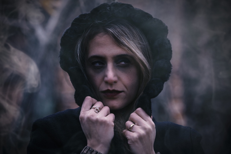 headshot, girl, looking at camera, wearing, hoodie, one person, beautiful woman, sad, focus, hand, close-up, young adult, hood, facial expression, contemplation
