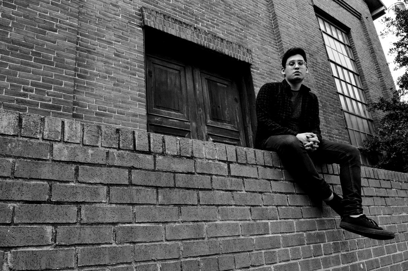 young adult, low angle shot, pose, black, men, portrait, person, photography, city, grayscale, young men, casual clothing, sad, front view, architecture