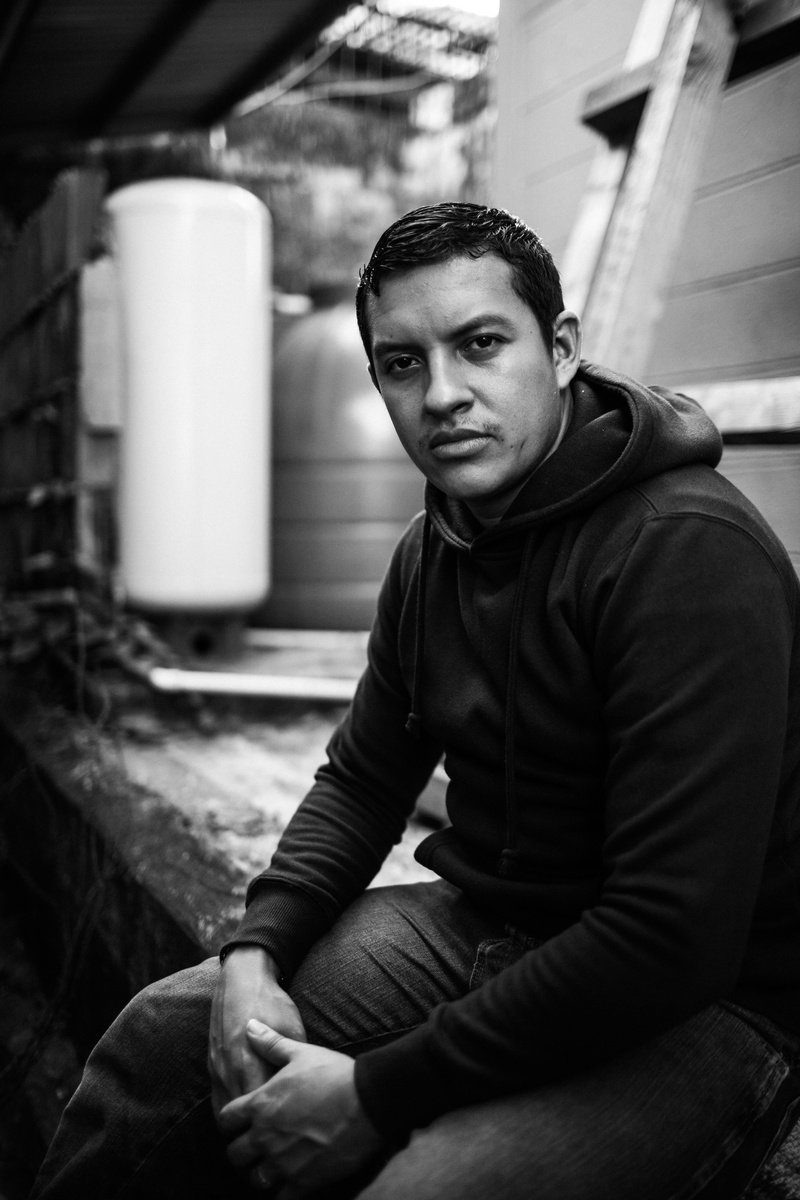 pose, sitting, young adult, focus on foreground, model, one person, style, outerwear, photoshoot, hoodie, man, looking at camera, clothing, outfit, male model