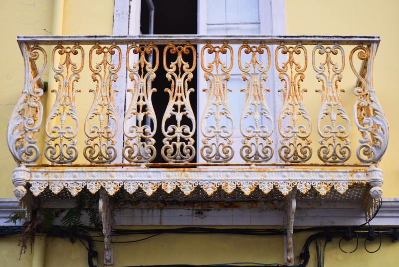wall - building feature, art and craft, isometrics, rust, railing, craft, floral pattern, low angle view, design, facade, building, window, building exterior