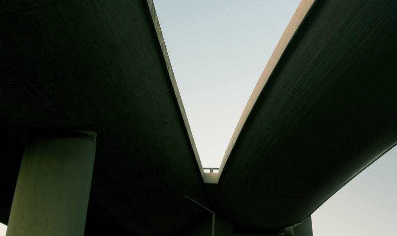 low angle view, building, place, clear sky, bridge, day, bridge - man made structure, connection, highway, outdoors, architectural column, green color