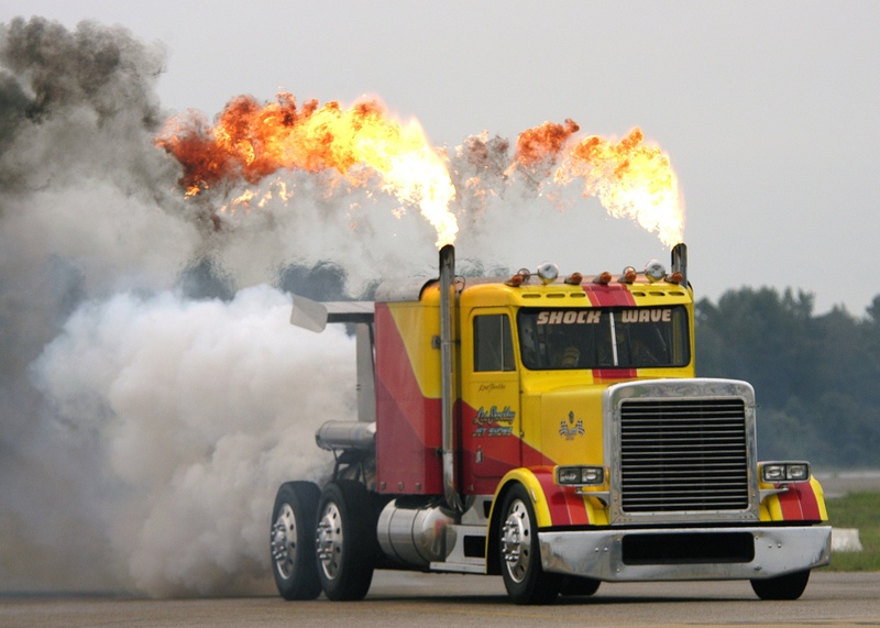 motor vehicle, military, modified, outdoors, truck, jet engines, custom jet propelled truck, vehicle, land vehicle, yellow, air show, sky, no people, accidents and disasters