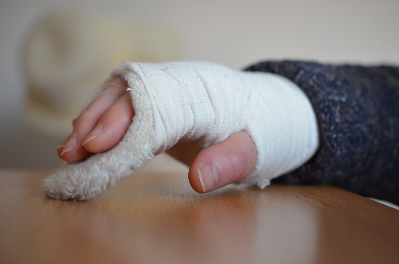 sleeve, indoors, childhood, close-up, body part, human limb, adult, fracture, hand, baby, human hand, child, human foot, one person, finger, association