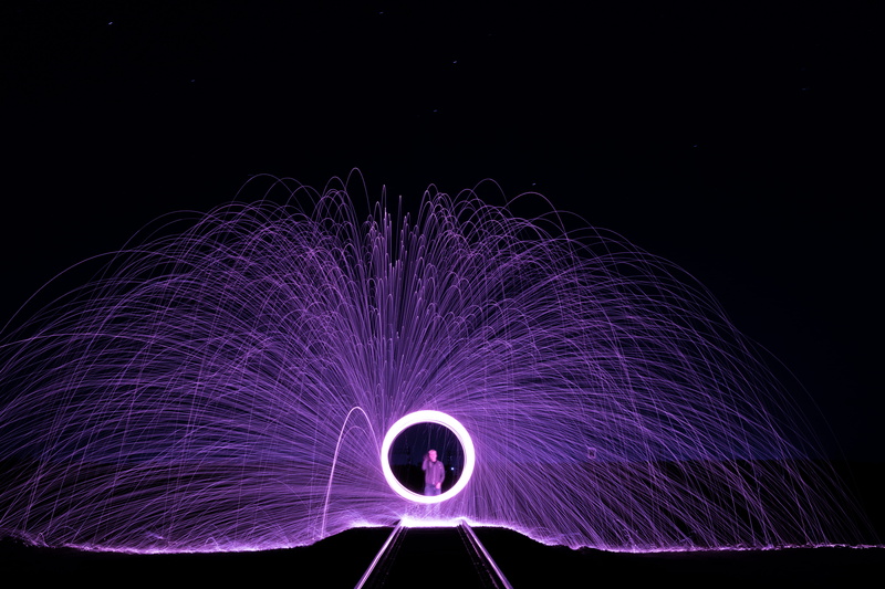 arts culture and entertainment, unrecognizable person, dark, studio shot, light painting, circle, black Color, train track, one person, wire wool, pattern