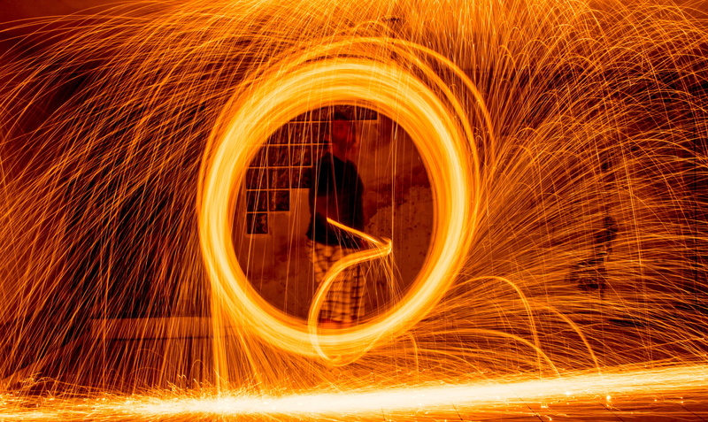 sparks, blurred motion, orange color, spinning, Steel Wool, Light Painting, wool, painting, one person, 2K, light, geometric shape, warning sign, outdoors