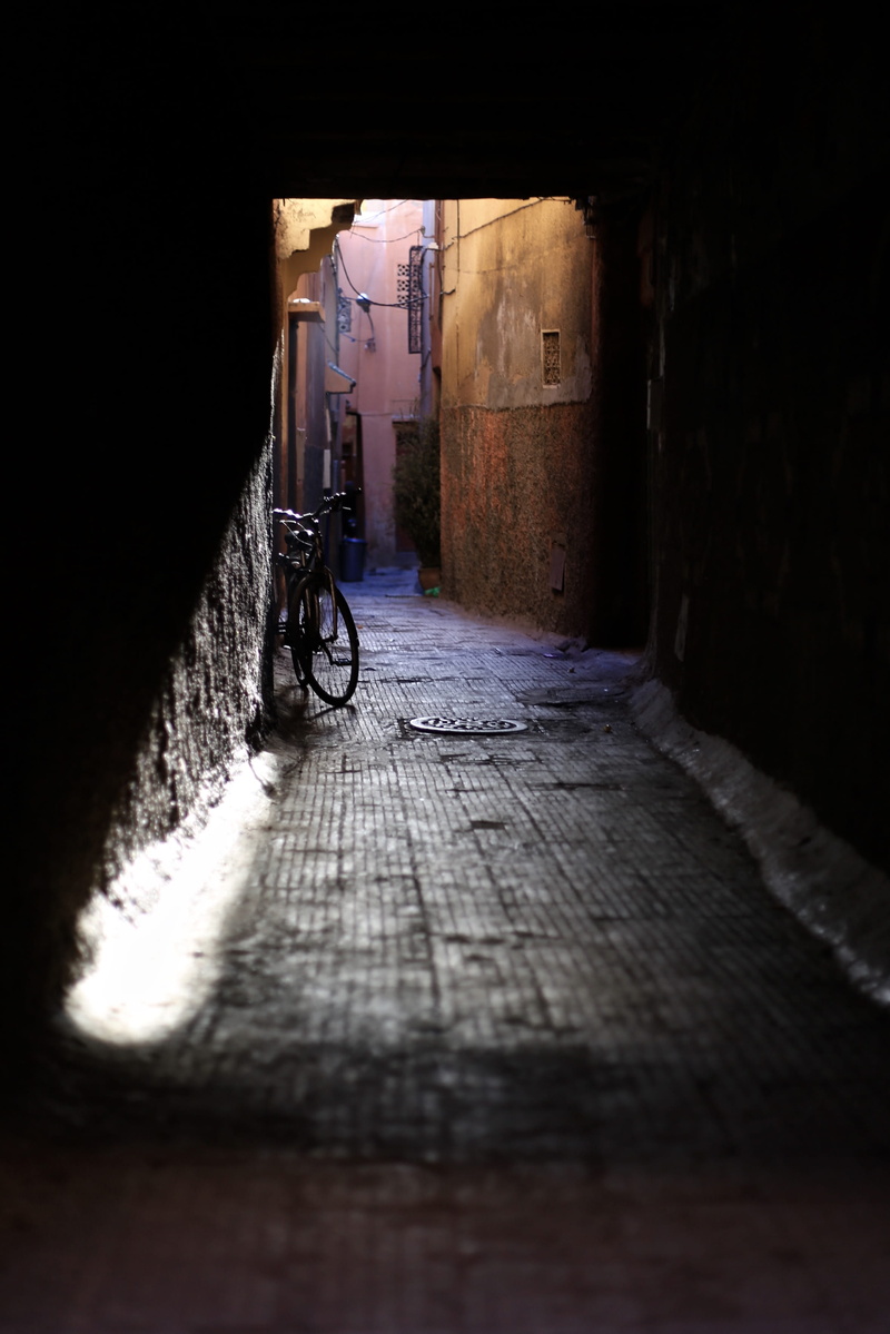 activity, contrast, transportation, building, doorway, architecture, land vehicle, hallway, travel, street, one person, wall, direction, near, bicycle