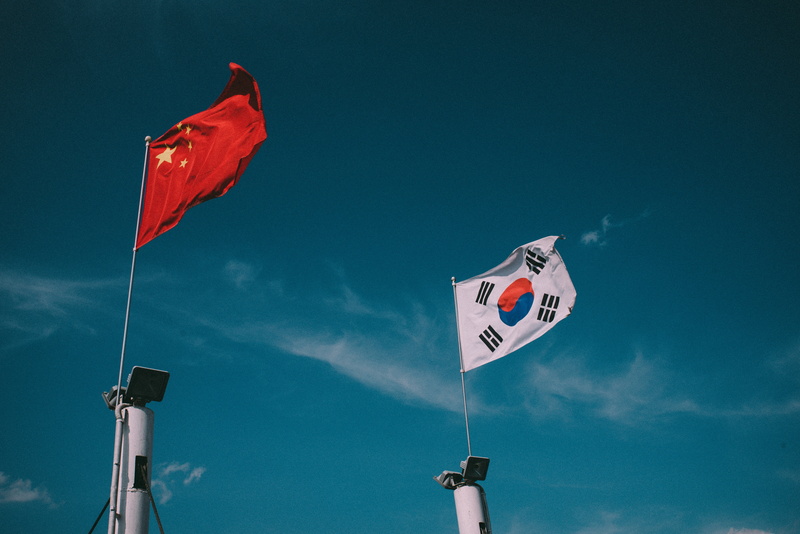 sky, nature, flag, korea, patriotism, cloud - sky, hand, human body part, wind, country, china, holding, outdoors, people, south, red, pole, day, low angle view
