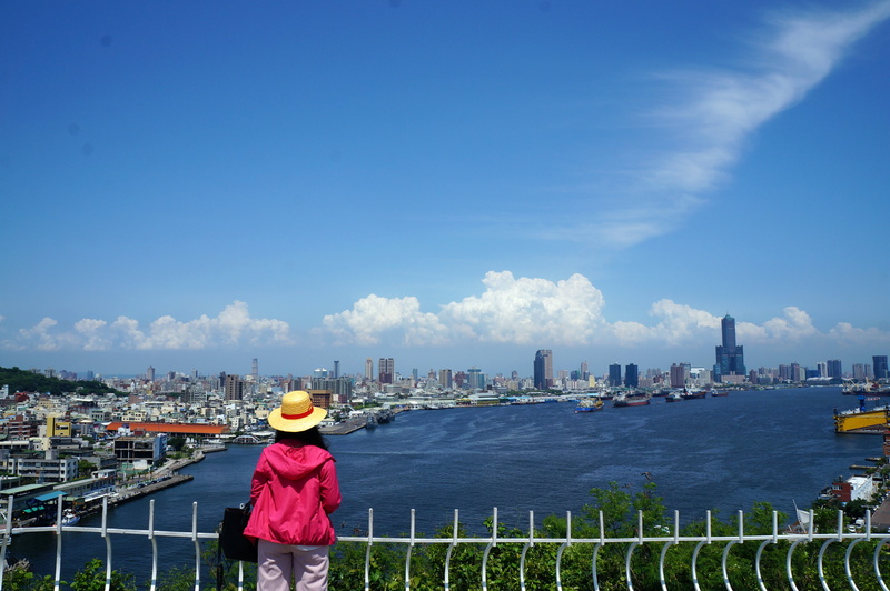 day, lifestyles, sky, water, railing, hat, real people, rear view, landscape, cityscape, office building exterior, one person, built structure, kaohsiung harbor