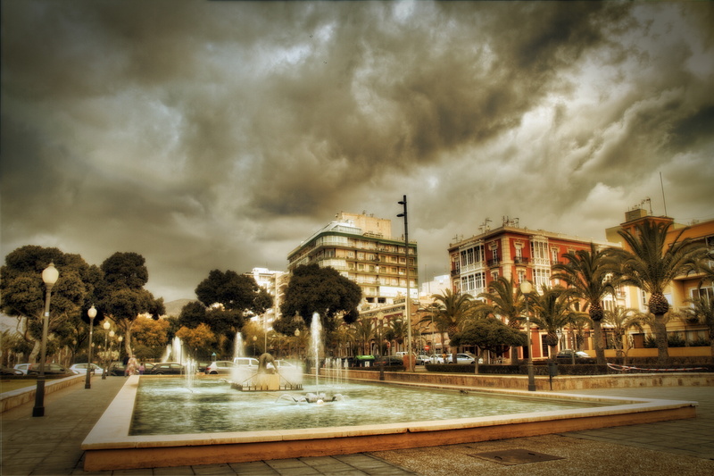 transportation, wet, built structure, cloud - sky, almeria, rain, plant, no people, nature, architecture, overcast, water, road, fountain pond, tree, outdoors