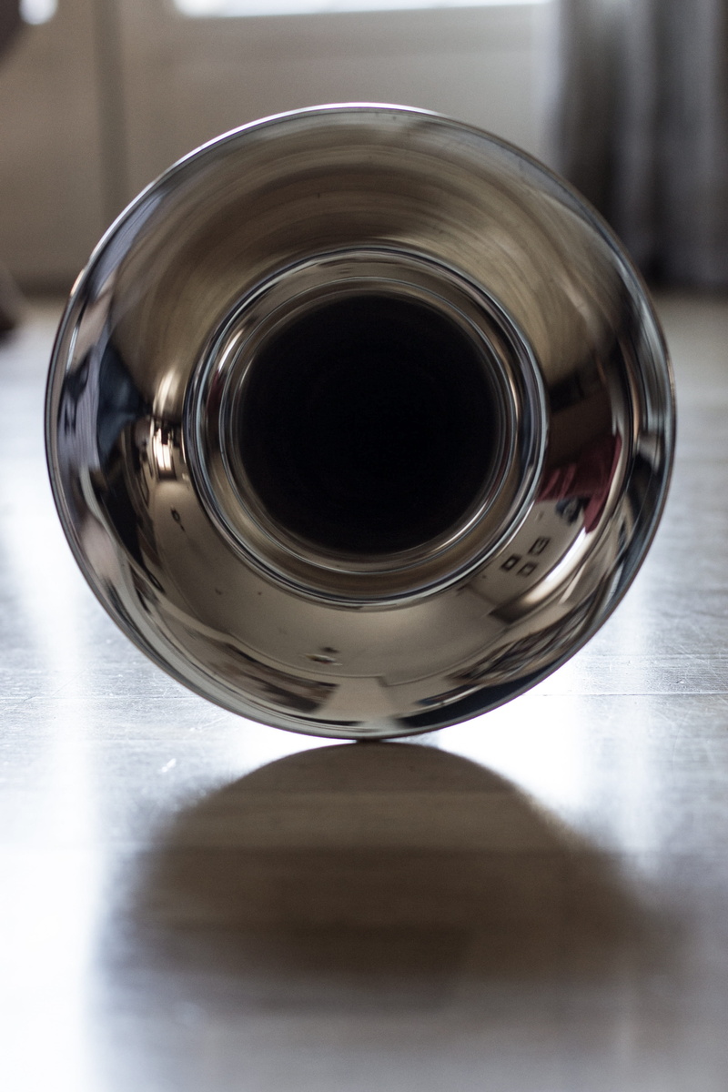 drink, geometric shape, metal, container, selective focus, focus on foreground, still life, bright, silver colored, indoors, table, brass, glass - material