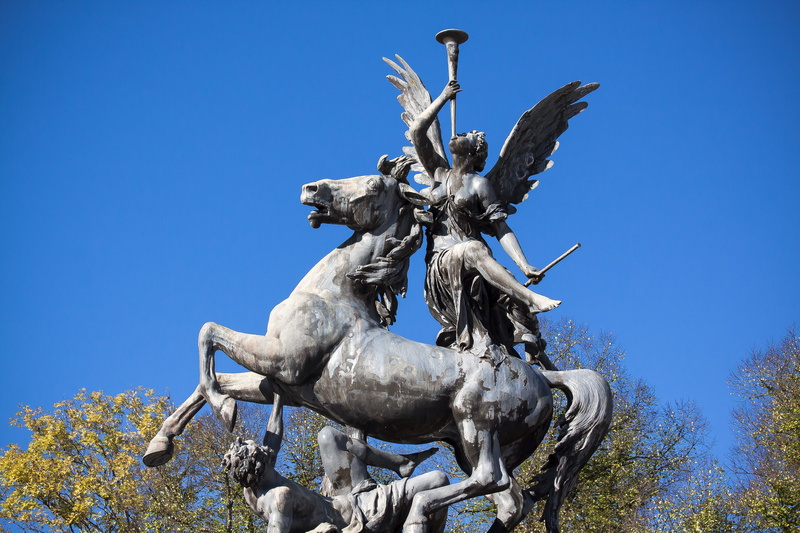 human representation, sky, low angle view, pegasus, male likeness, nature, architecture, outdoors, spain, the past, art, day, bronze, trombone, blue, fama