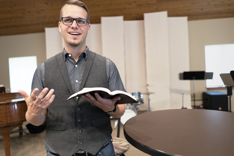 front view, preaching, casual clothing, adult, smiling, standing, holding, music, waist up, happiness, young adult, 8K, pastor, one person, portrait, indoors