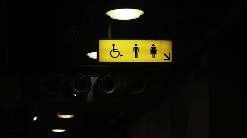 light, illuminated, text, domestic room, communication, architecture, lighted, restroom sign, yellow, public restroom, clock, indoors, sign, dark, information sign