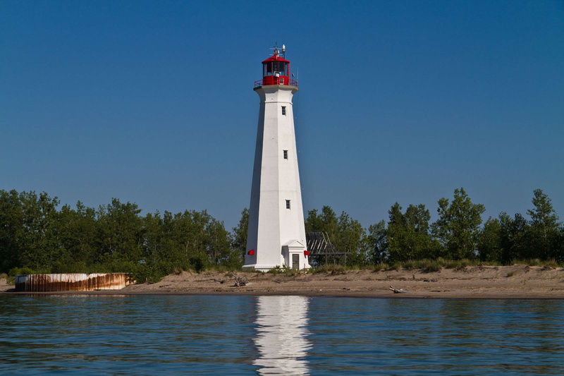 outdoors, 1080P, building exterior, landscape, day, blue, safety, lake, direction, tower, security, built structure, light, clear sky, tree, danger, water