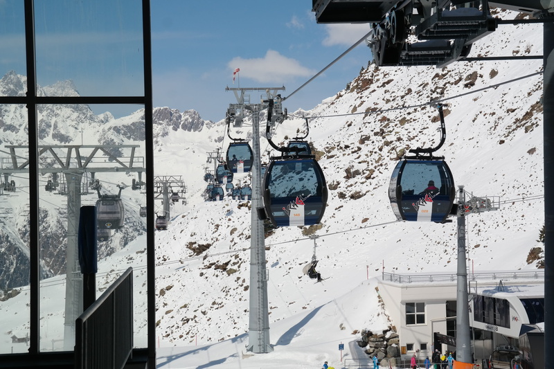 gondolas, incidental people, building, mountain, outdoors, cold temperature, cable car, sky, winter, building exterior, technology, architecture, snow
