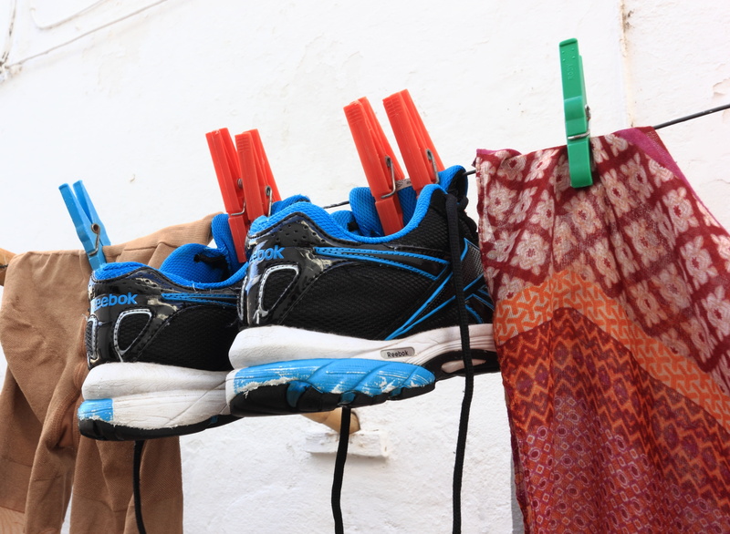 textile, evora, built structure, chair, washing, laundry, dry, no people, shoes, clothes, red, seat, pair, reebok, outdoors, sunlight, hanged, group of objects