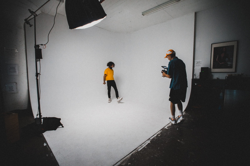 production, casual clothing, man, photographer, indoors, cooperation, indoor, palace, coworker, standing, dark, camerea, teamwork, white backdrop, lighting