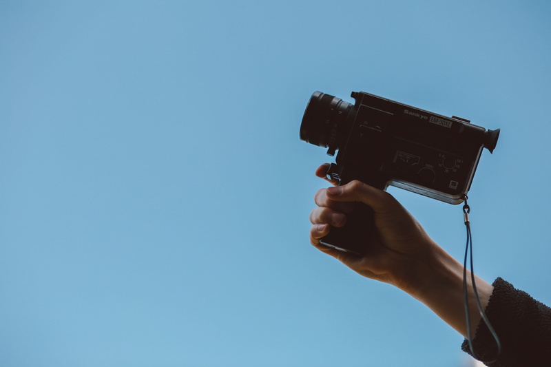 home video camera, clear sky, real people, photographic equipment, people, lifestyles, camera - Photographic Equipment, sky, 5K, hand, outdoors, adults only