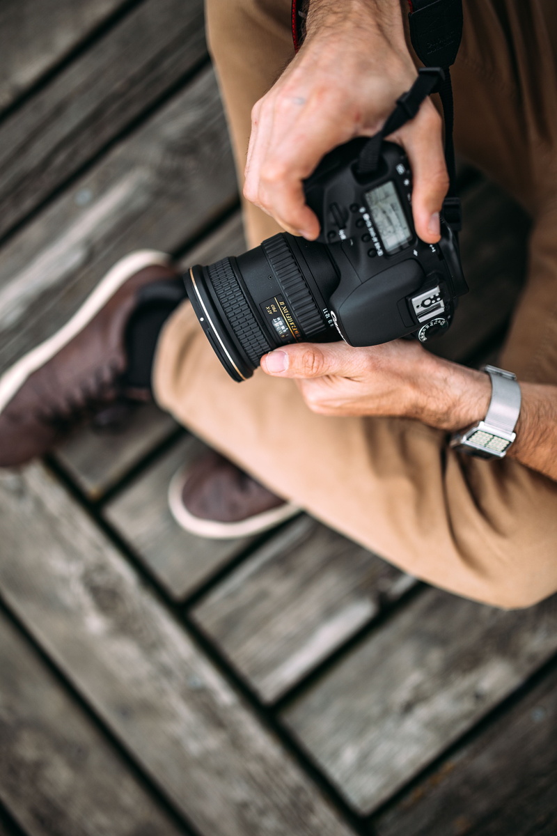 wood - material, human body part, camera, one person, lifestyles, close-up, focus on foreground, outdoor, men, photography themes, high angle view, young