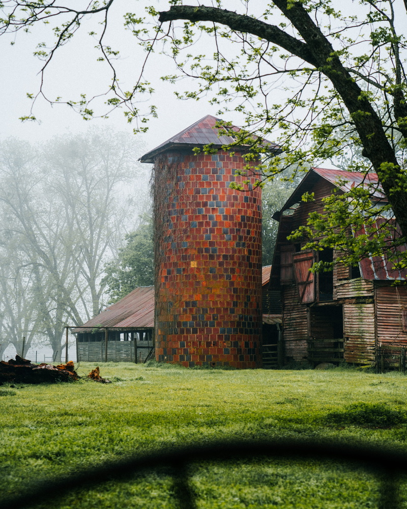 tower, pile, brick, agricultural building, brown, day, outdoors, beside, barn, farm, countryside, concrete, no people, housing, field, lawn, built structure
