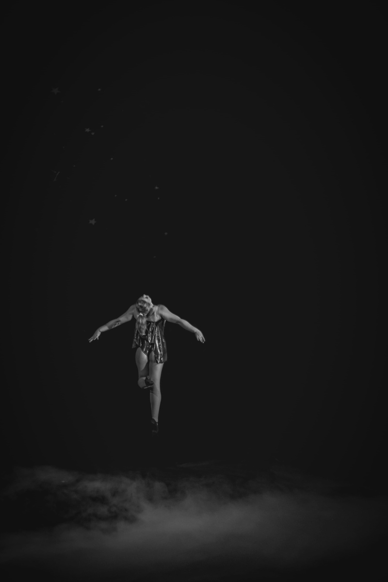 standing, copy space, clothing, real people, angel, black and white, arms outstretched, magic, levitation, black background, beauty, indoors, smoke, dancing