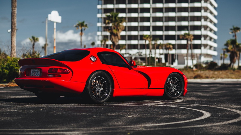 muscle car, motor vehicle, mode of transportation, sports car, red car, car, built structure, chrysler viper, city, luxury, road, architecture, day, transportation