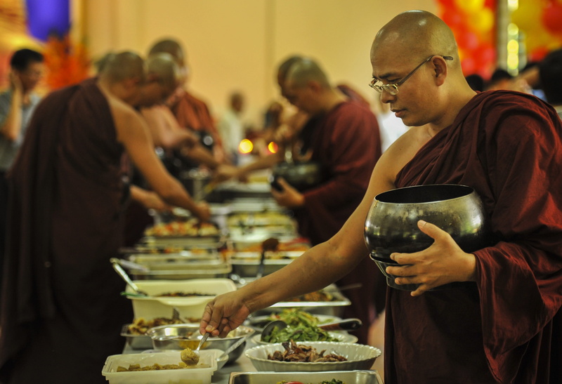 side view, buddhist, praying, monks and food, real people, monk - Religious Occupation, Theravada Buddhism, indoors, incidental people, table, monastery