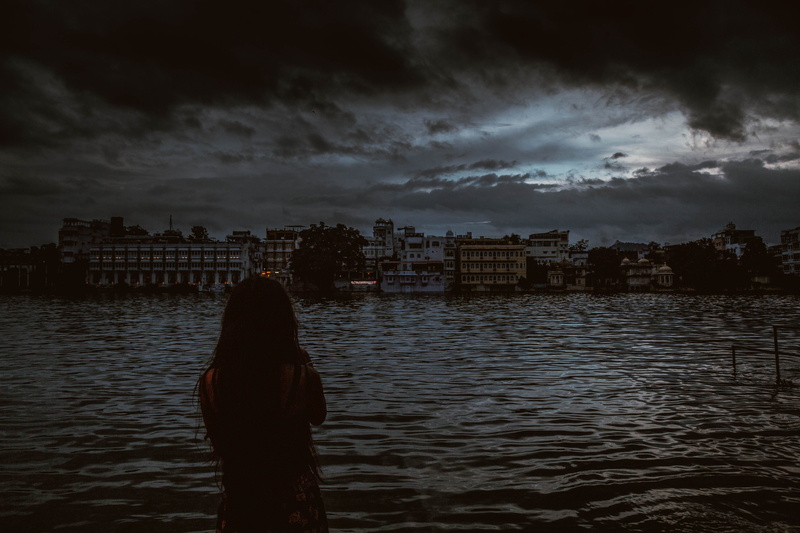 cityscape, looking at view, 5K, building exterior, standing, city, lake, water, sky, cloud - sky, one person, real people, river, women, architecture