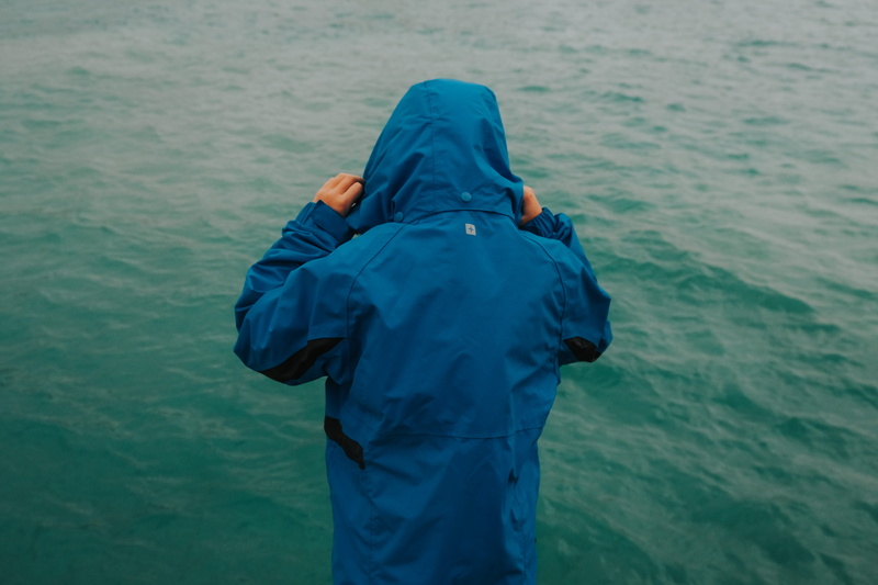 turquoise colored, travel, fish, parka, beauty in nature, apparel, nature, lifestyles, one person, rear view, coat, day, coho, explore, water, hood - clothing