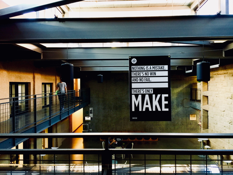 sign, stanford, script, people, public transportation, building, information, prison, united states, architecture, non-western script, day, railing, handrail