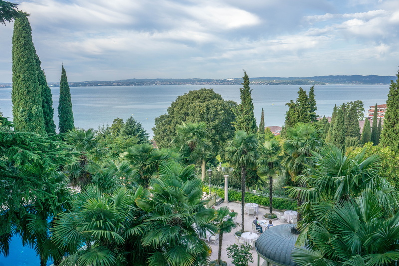 coconut palm tree, luxury, cloud - sky, lake garda, tranquility, tourism, pool, tranquil scene, day, landmark, view, scenics - nature, palm tree, tropical climate