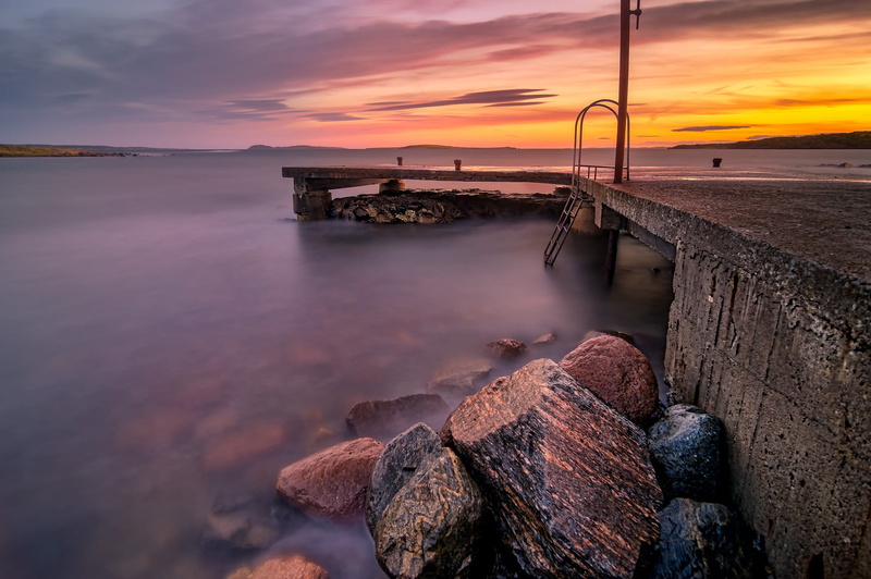horizon over water, sea, idyllic, orange color, pebble, tranquility, table, tranquil scene, long exposure, groyne, outdoors, sunset, land, sky, scenics - nature