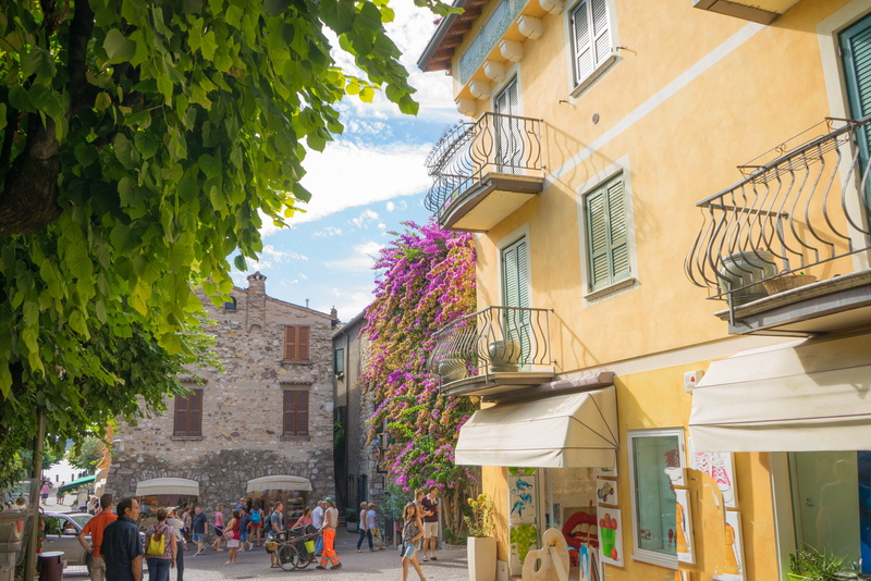 flowers, men, architecture, old, tourism, low angle view, 5K, travel, women, outdoors, city, window, real people, europe, plant, building exterior, medieval