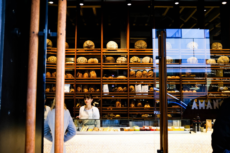 standing, cabinet, large group of objects, lifestyles, reflection, shelf, bread, glass, server, men, working, auckland, people, counter, shop, shelves