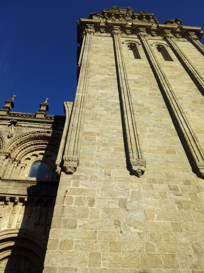 building exterior, outdoors, low angle view, building, ancient civilization, sunlight, history, galicia, sky, place of worship, santiago of compostela