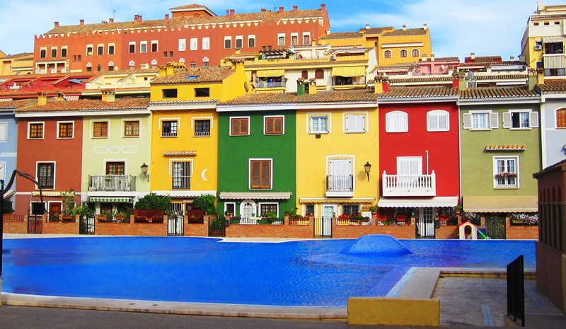 city life, residential district, built structure, multi colored, port saplaya, architecture, swimming pool, spain, no people, sky, street, day, building exterior