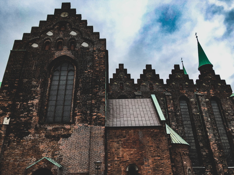 religion, cityscape, brick, low angle view, outdoors, church, travel destinations, building, skyscraper, day, place of worship, nature, kirka, history