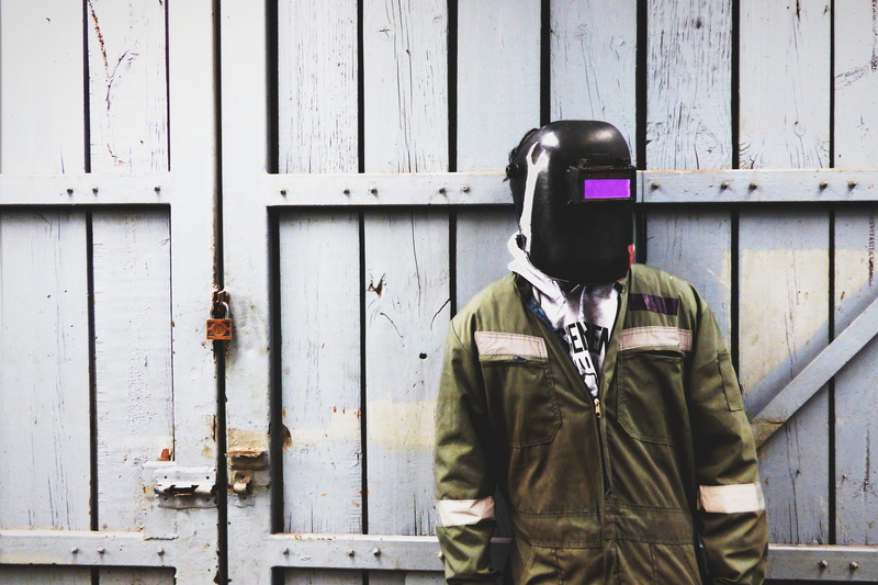coverall, uniform, standing, leisure activity, worker, unrecognizable person, helmet, waist up, one person, workshop, lifestyles, front view, wood - material