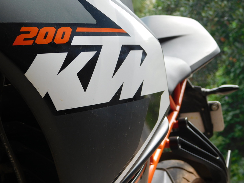 focus on foreground, KTM RC200, car, land vehicle, transportation, communication, day, western script, mode of transportation, 4K, no people, text, close-up